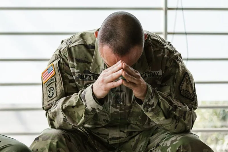 Veteran-suffering-from-traumatic-memories-touching-his-head.-800x533